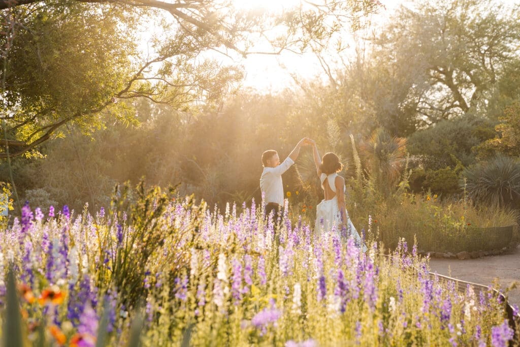 Couple's engagement photos in Desert Botanical Garden with spring flowers and lavender blooms. 
