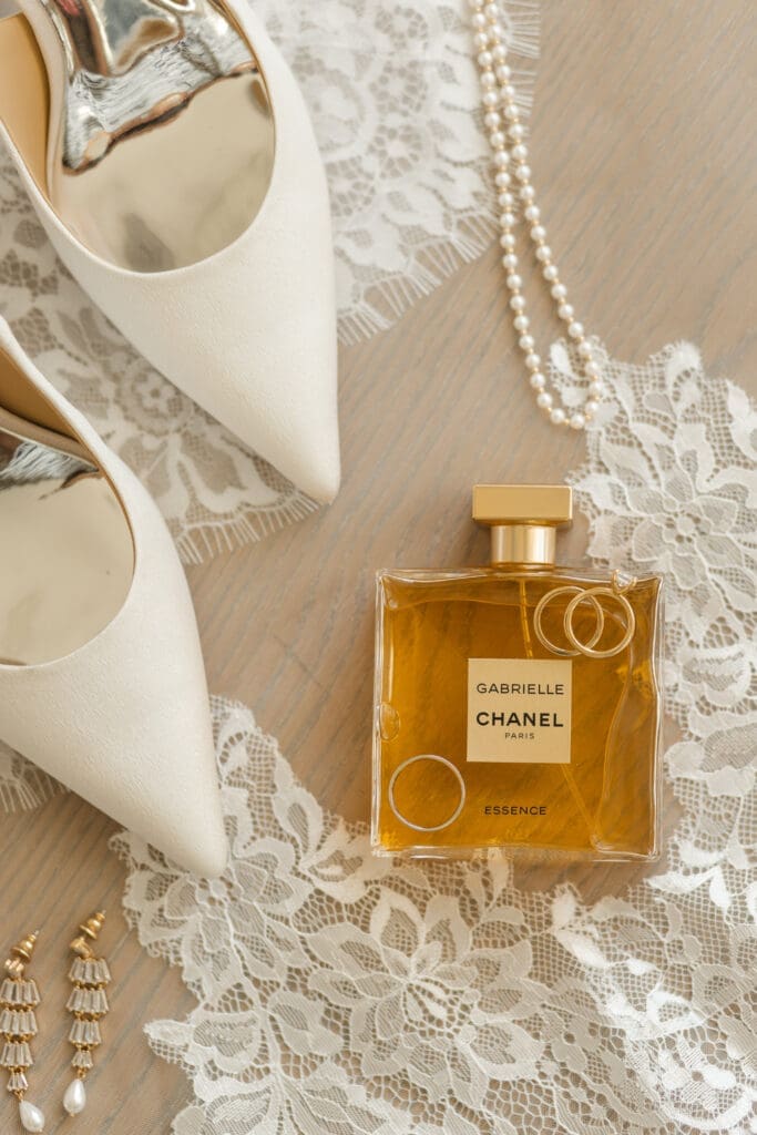 Bridal shoes, perfume, and engagement ring close up details