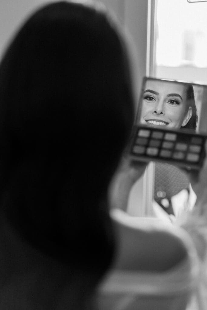 Bride getting ready with her makeup before church ceremony