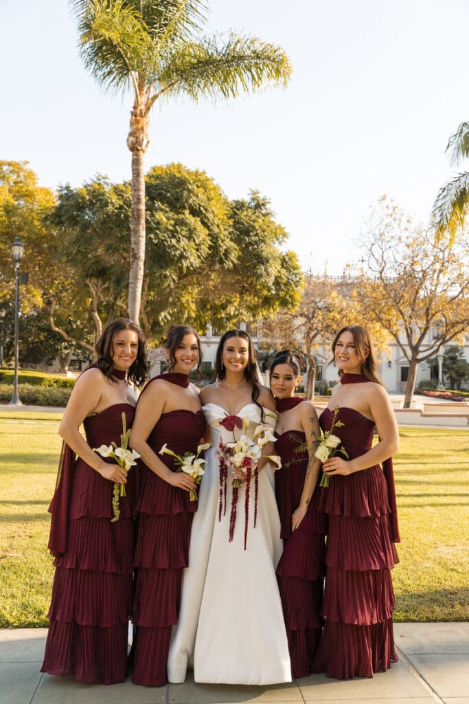 Bride and bridal dressed in dark burgundy.